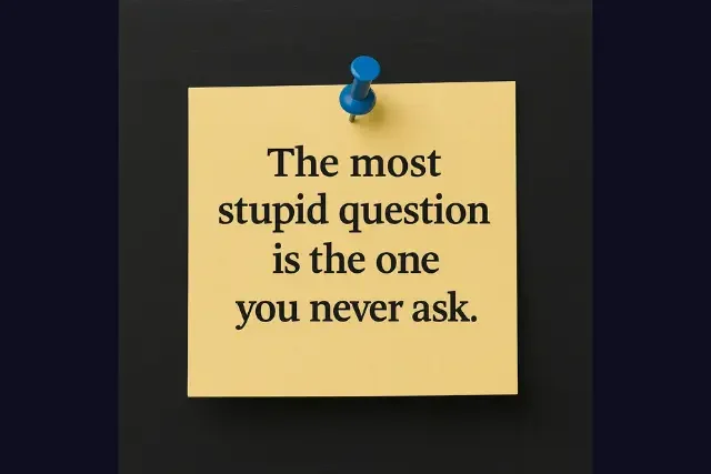 Yellow sticky note with the quote “The most stupid question is the one you never ask,” pinned to a black chalkboard background